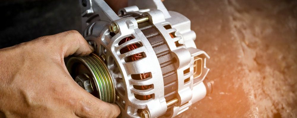 Change new car alternator with hand in the garage or auto repair service center, as background automotive concept. Dark tone.
